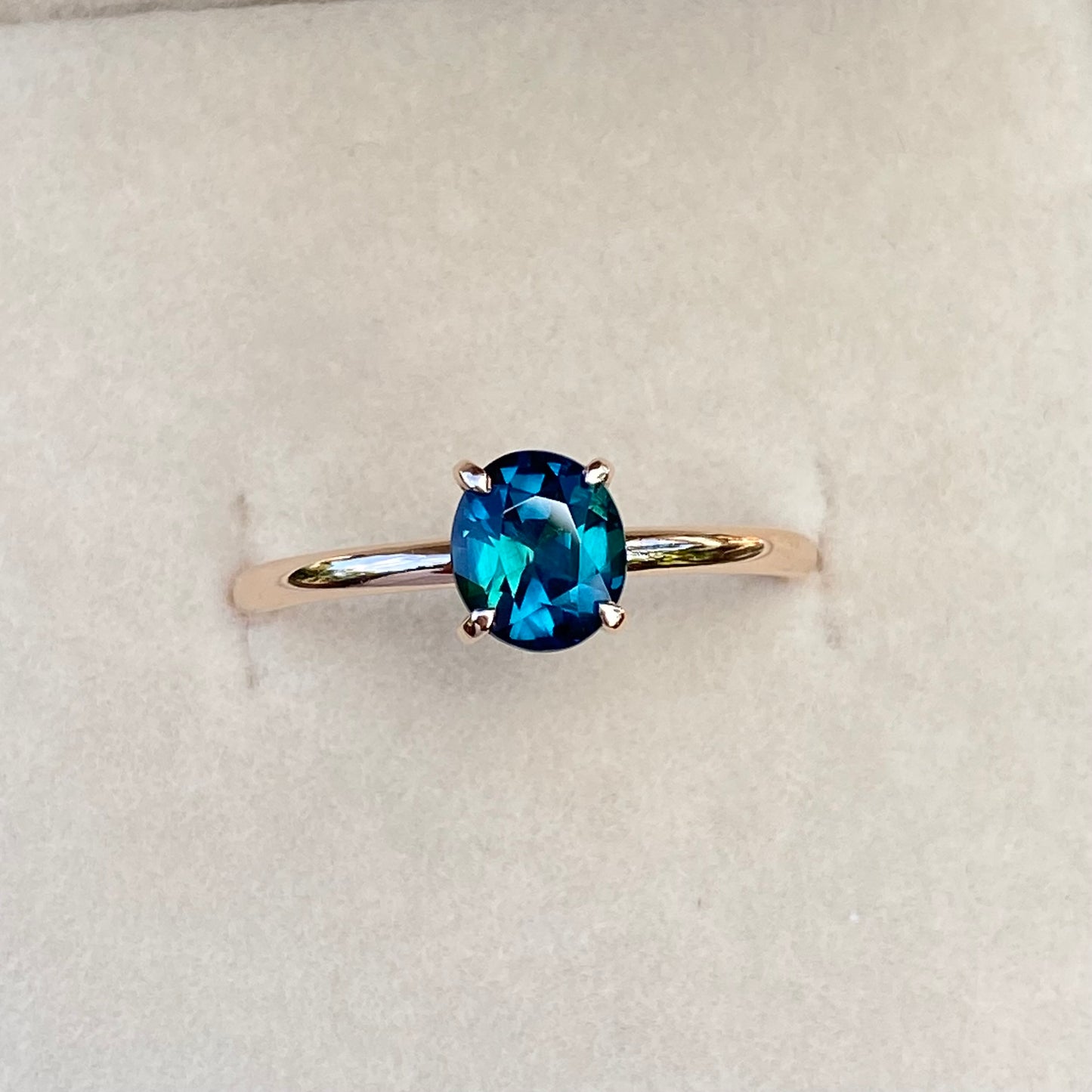 Oval Peacock Sapphire simple solitaire ring, 14K Rose gold.