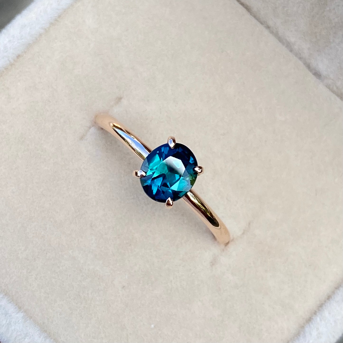 Oval Peacock Sapphire simple solitaire ring, 14K Rose gold.